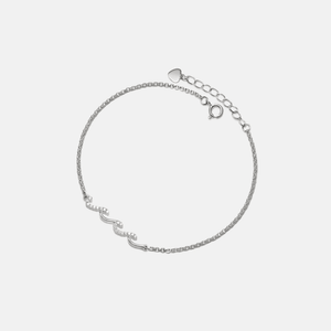 A two-tone gold-plated sterling silver bracelet with a geometric pattern and a central charm.