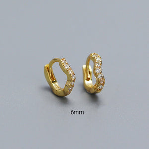 A collection of hoop earrings in various sizes, with some plated in gold and others in silver, all featuring cubic zirconia.