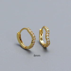 A collection of hoop earrings in various sizes, with some plated in gold and others in silver, all featuring cubic zirconia.