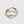 A gold stacking ring with curved wave design, displayed on a plain background.