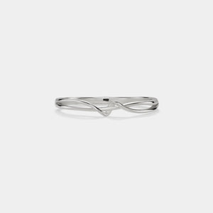 Silver ring with a wavy design on a white background
