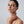 Woman touching her neck with a neutral background