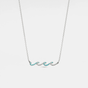 A gold-plated sterling silver necklace with a charm designed to resemble ocean waves, accented with small blue cubic zirconia.