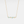 Gold necklace with turquoise stones on a light gray background