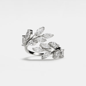 A gold-plated sterling silver cocktail ring with a bypass design featuring clear cubic zirconia stones arranged in an olive leaf pattern on a white background.
