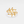Gold leaf-shaped ring on a light gray background