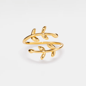 Gold leaf-shaped ring on a light gray background