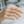 Hand wearing a gold ring with small stones on a blurred background