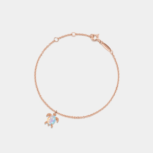 A gold-plated sterling silver bracelet with an opal sea turtle charm, on an adjustable chain.