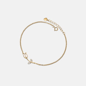 Gold bracelet with a delicate design on a light beige background