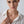 Woman wearing a gold necklace with a white shirt on a plain background