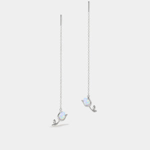 Pair of silver earrings with opal stones on a light gray background