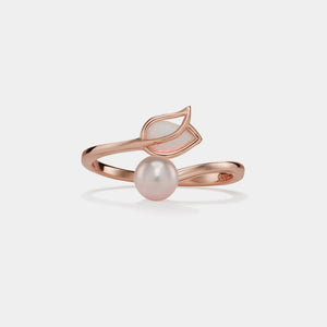 Rose gold ring with a pearl on a light gray background
