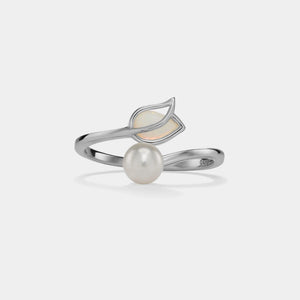 Silver ring with a pearl and leaf design on a light gray background
