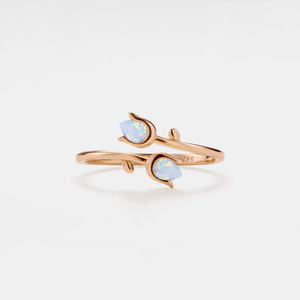 A gold-plated sterling silver ring with opal inlays designed in a bypass style, resembling a tulip flower.