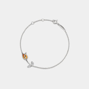 Silver bracelet with butterfly charm on a white background