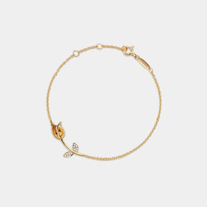 Gold bracelet with leaf-shaped charms on a white background
