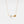 Gold necklace with leaf design on a white background