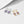 Two pairs of earrings with purple gemstones on a white background