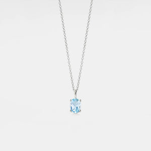 Necklace with a blue gemstone pendant on a light gray background