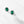 Pair of emerald green gemstone earrings on a white background