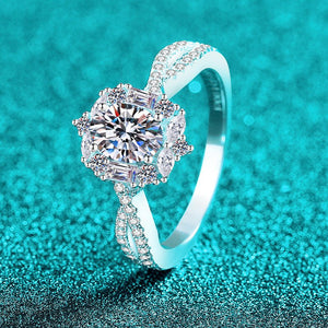 Silver ring with a large diamond on a turquoise glittery background