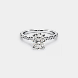 Diamond ring with a white gemstone on a light gray background