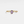 Gold ring with a purple gemstone on a white background