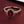 Gold ring with a red gemstone and diamond accents on a dark red background