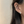 Close-up of an ear wearing a small earring with a blurred background