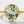 Gold ring with a green moss stone on a white background