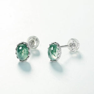 Pair of green gemstone stud earrings on a white background