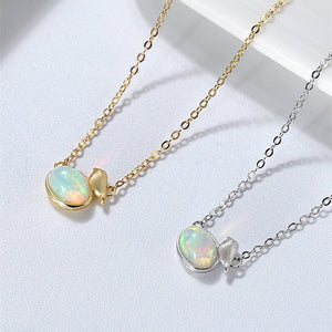 Two necklaces with opal stones on gold and silver chains against a light background
