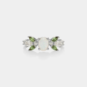 Pair of earrings with opal and green gemstones on a white background