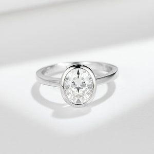 Silver ring with a diamond on a light gray background