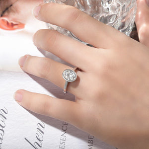 Silver ring with a diamond on a hand against a white background