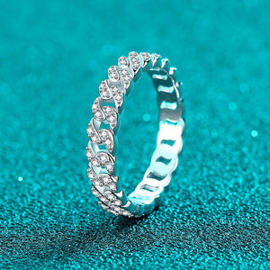 Silver ring with diamonds on a teal background