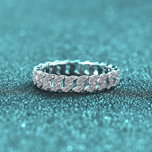 Silver chain bracelet with clear stones on a glittery blue background