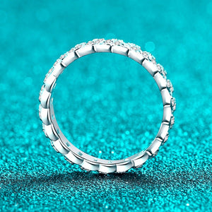 Silver ring with embedded stones on a turquoise background