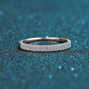 Silver ring with diamonds on a blue glittery background