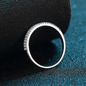 Silver ring with small stones on a textured black surface