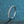 Silver ring with small stones on a blue textured background