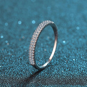 Silver ring with small stones on a blue textured background