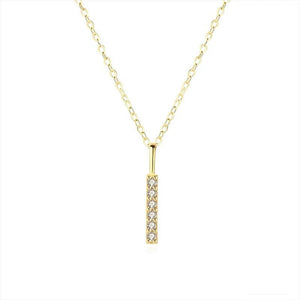 A gold-plated sterling silver bar pendant necklace with cubic zirconia, displayed on a black background.
