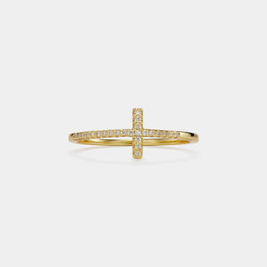 Gold cross-shaped ring with diamonds on a light gray background