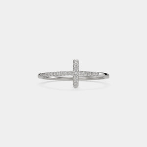 Silver cross-shaped ring with small diamonds on a light gray background