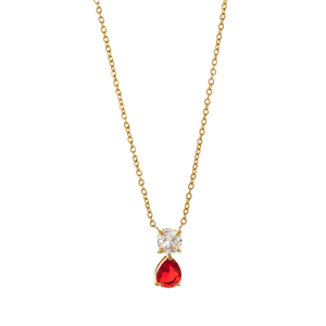 Gold necklace with a red teardrop pendant and clear gemstone on a white background
