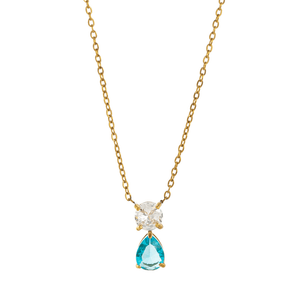 Gold necklace with a teardrop-shaped blue gemstone and clear stone on a white background