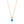 Gold necklace with a blue teardrop pendant and clear gem on a white background