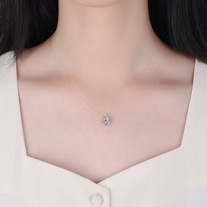Teardrop-shaped necklace with a pendant on a person wearing a white shirt.